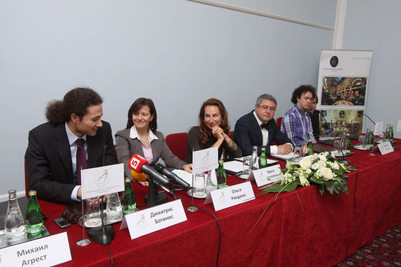 Participants of the press-conference listen attentively to Dimitris Botinis (conductor, Greece)